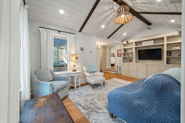 living area featuring a ceiling fan, wooden ceiling, vaulted ceiling with beams, and wood finished floors