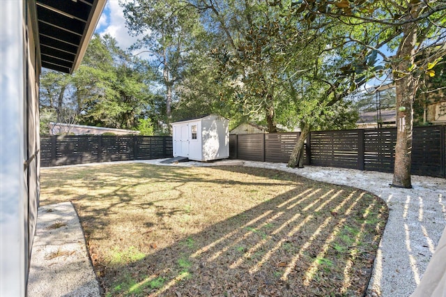 view of yard featuring a fenced backyard, a shed, and an outdoor structure