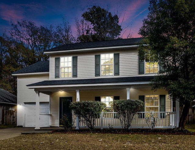 view of front facade with a porch and a garage