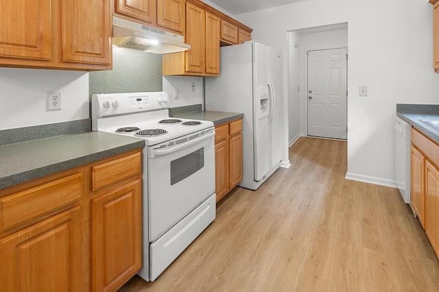 kitchen with white appliances and light hardwood / wood-style flooring