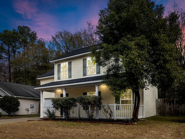 view of front of home featuring covered porch and a garage