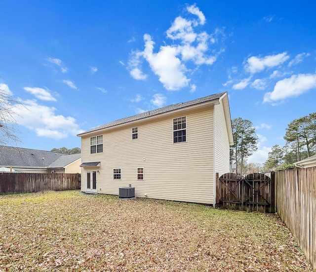 rear view of house featuring french doors and cooling unit