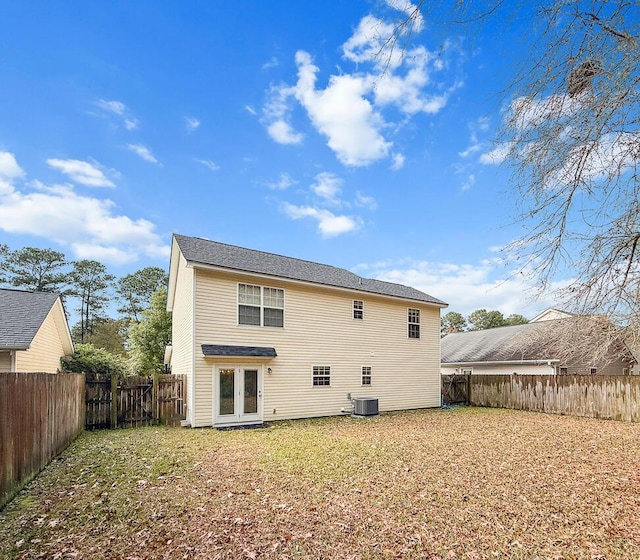 rear view of house featuring french doors and cooling unit