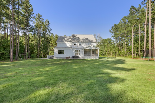 1130 Plantation Overlook Dr, Moncks Corner, SC 29461 - rear view of property featuring a trampoline, a sunroom, and a lawn