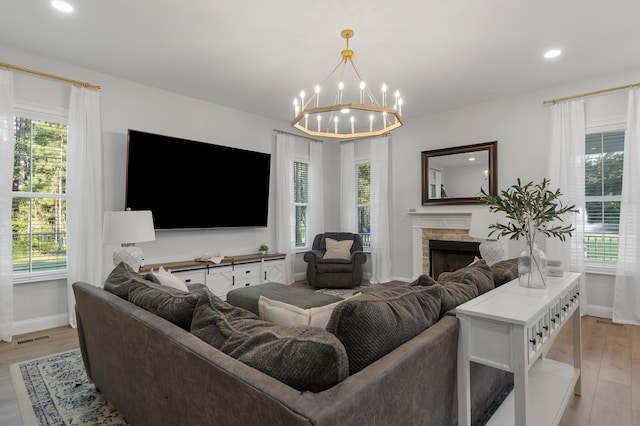 1130 Plantation Overlook Dr, Moncks Corner, SC 29461 - living area with healthy amount of natural light, light wood-type flooring, recessed lighting, and a chandelier