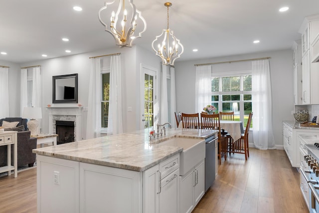 1130 Plantation Overlook Dr, Moncks Corner, SC 29461 - kitchen featuring stainless steel appliances, recessed lighting, a fireplace, a chandelier, and light wood-style floors
