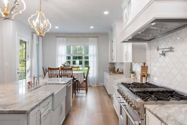 1130 Plantation Overlook Dr, Moncks Corner, SC 29461 - kitchen with stainless steel appliances, premium range hood, a chandelier, recessed lighting, and light wood-style floors