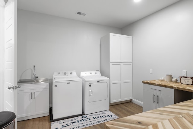 1130 Plantation Overlook Dr, Moncks Corner, SC 29461 - laundry room featuring washer and dryer, light wood-type flooring, and cabinet space