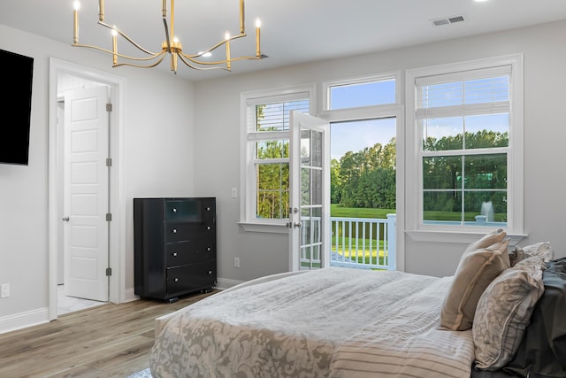1130 Plantation Overlook Dr, Moncks Corner, SC 29461 - bedroom with a chandelier, wood finished floors, and access to outside