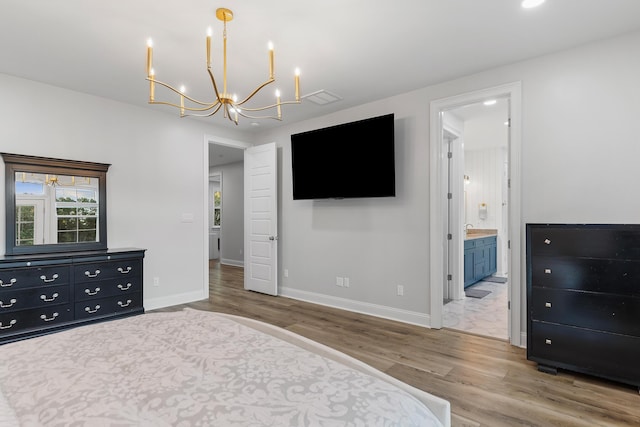 1130 Plantation Overlook Dr, Moncks Corner, SC 29461 - bedroom with wood finished floors, a chandelier, and ensuite bath