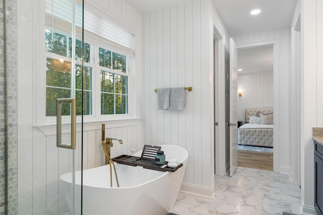1130 Plantation Overlook Dr, Moncks Corner, SC 29461 - bathroom with ensuite bath, marble look tiles, a freestanding tub, vanity, and wooden walls