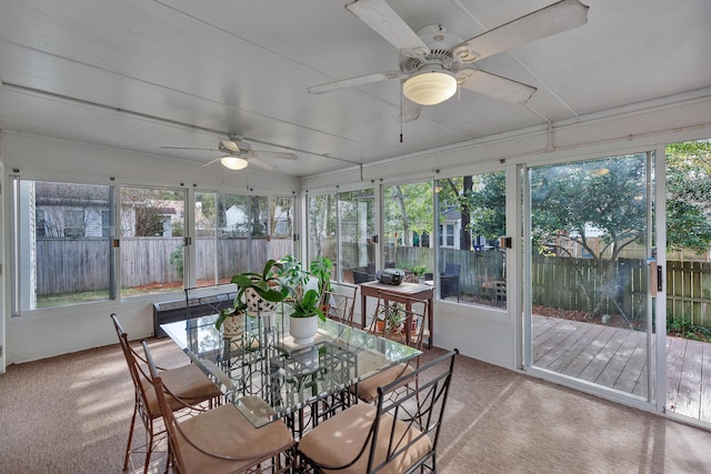 sunroom / solarium featuring a ceiling fan