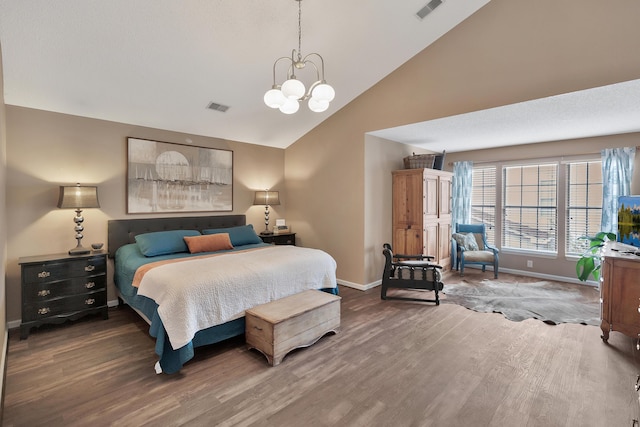 bedroom featuring a chandelier, visible vents, baseboards, and wood finished floors