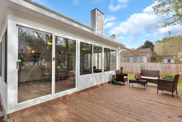 wooden deck with outdoor lounge area and fence