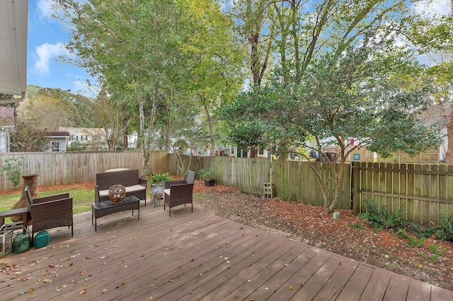 wooden terrace featuring a fenced backyard and an outdoor living space