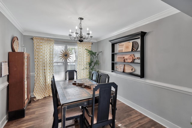 dining area with dark wood-type flooring, crown molding, and a notable chandelier