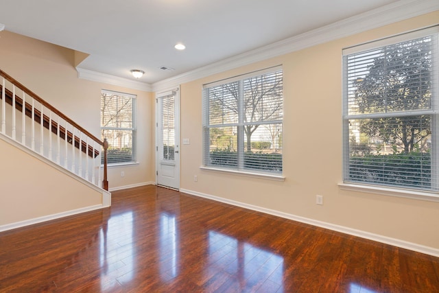 foyer featuring ornamental molding and dark wood-type flooring