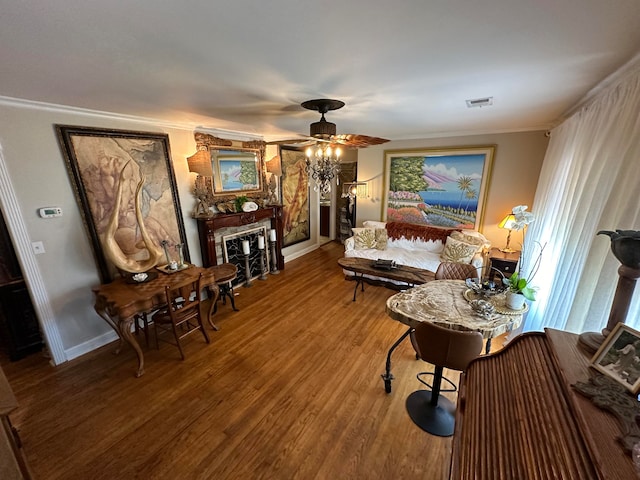 living room featuring ceiling fan, hardwood / wood-style floors, and crown molding