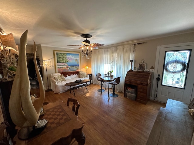 living room featuring hardwood / wood-style floors, crown molding, and ceiling fan