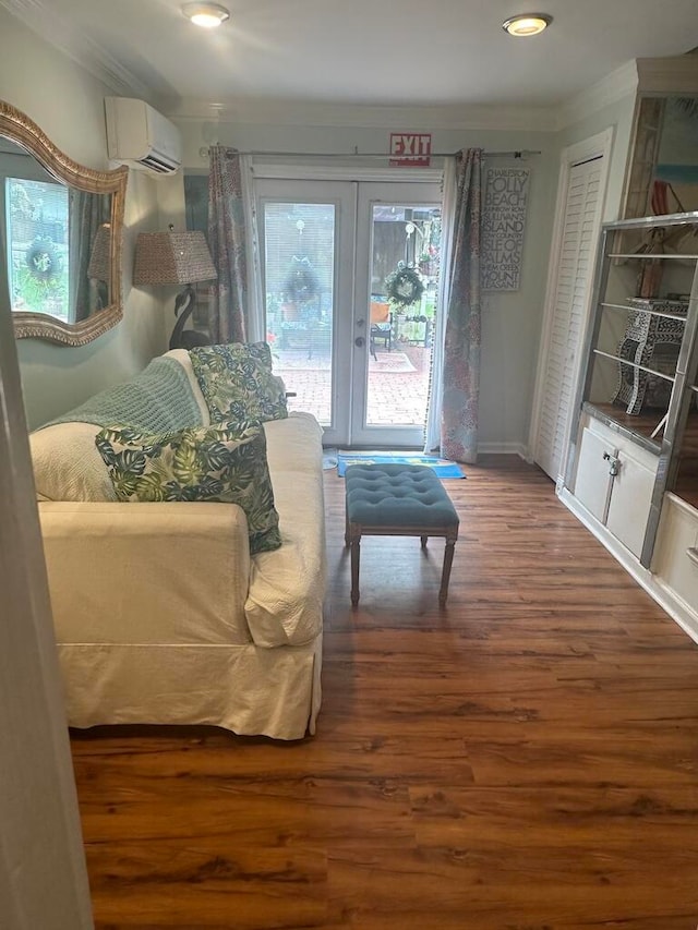 living room featuring hardwood / wood-style flooring, french doors, and a wall unit AC