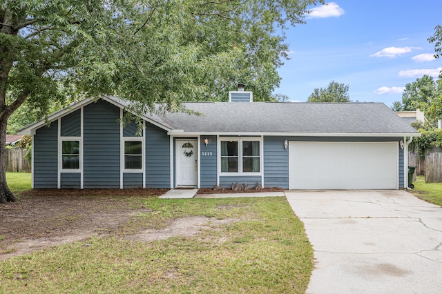 view of front of property with a chimney, a front lawn, concrete driveway, and a garage