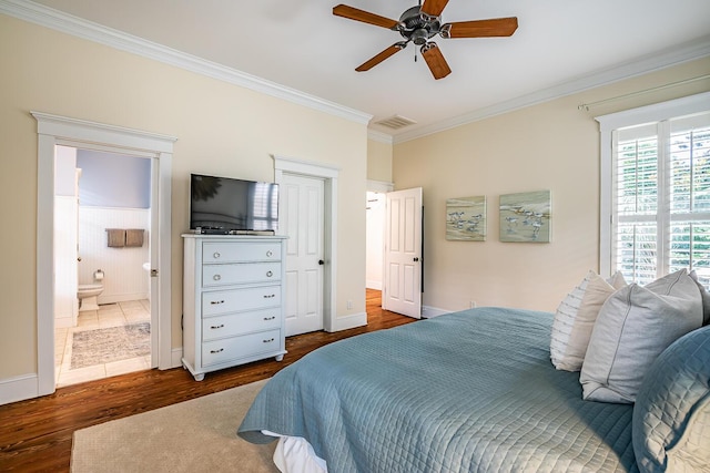 bedroom featuring ceiling fan, dark wood-type flooring, connected bathroom, and crown molding