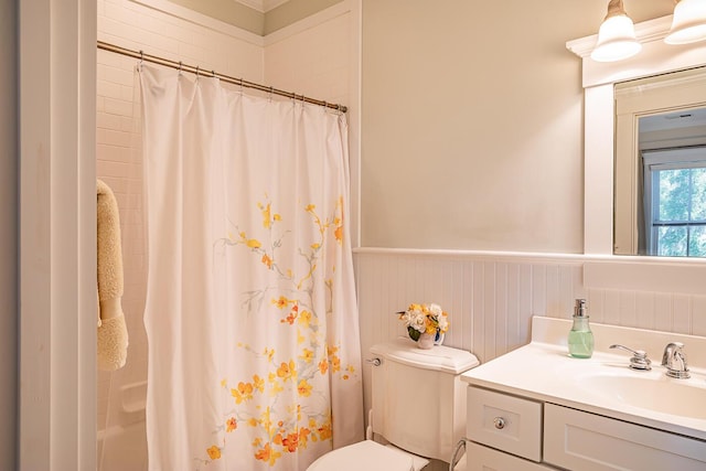 bathroom featuring toilet, walk in shower, and vanity