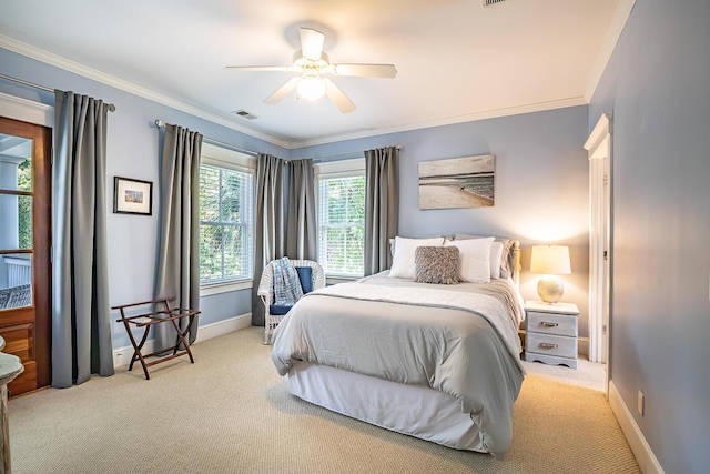 carpeted bedroom with ceiling fan and crown molding