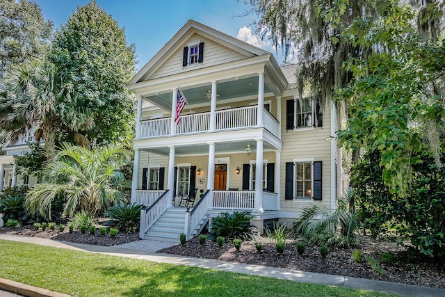 view of front of house featuring covered porch, a balcony, and ceiling fan