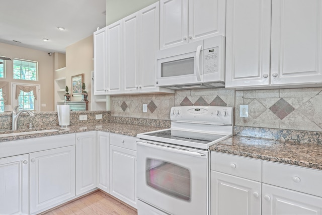 kitchen with sink, light hardwood / wood-style floors, white appliances, decorative backsplash, and white cabinets