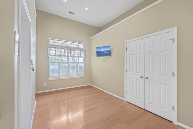 unfurnished bedroom with light hardwood / wood-style floors and a closet