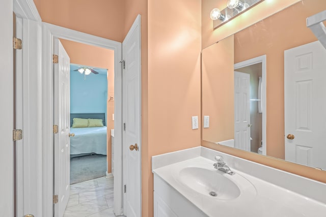 bathroom with ceiling fan, vanity, and toilet