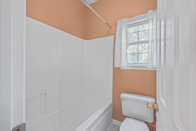 bathroom featuring shower / bath combination and toilet