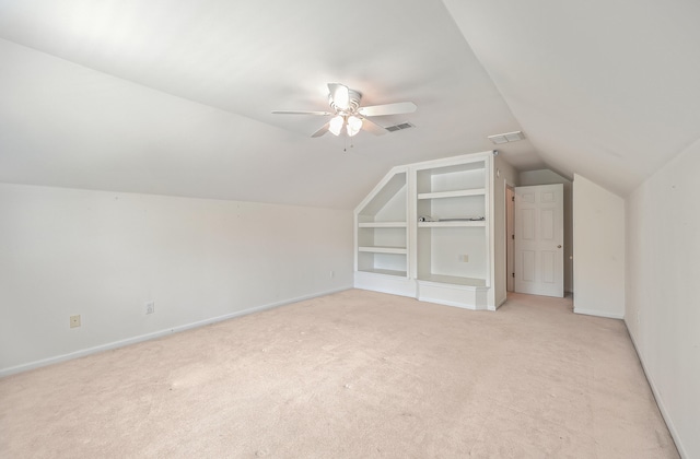 bonus room featuring ceiling fan, light colored carpet, and lofted ceiling