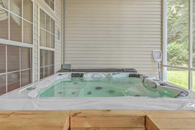 details with a hot tub and wood walls