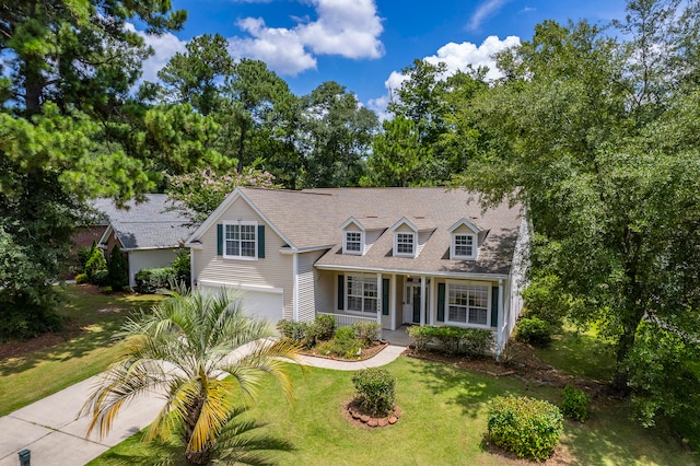 cape cod home with a porch, a garage, and a front yard