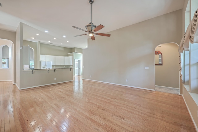 unfurnished living room with ceiling fan and light wood-type flooring