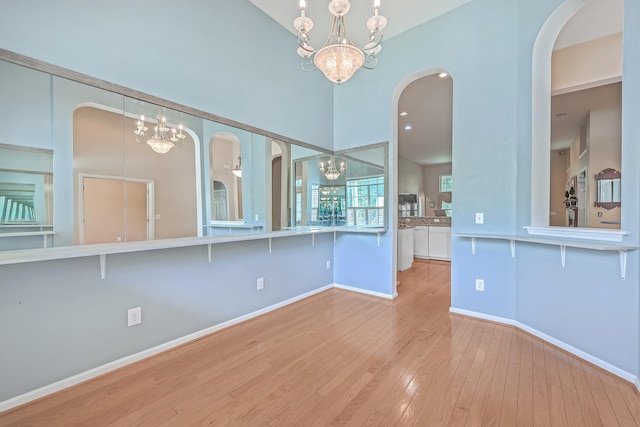 interior space with an inviting chandelier and light hardwood / wood-style flooring