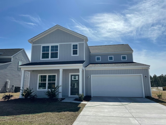 view of front of home with a garage and a front lawn