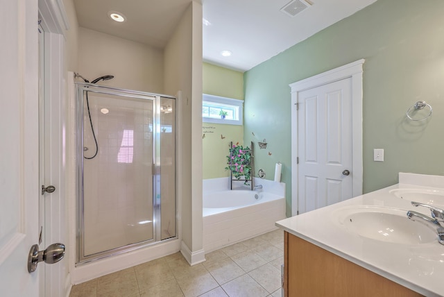 bathroom with tile patterned flooring, a stall shower, visible vents, and a sink