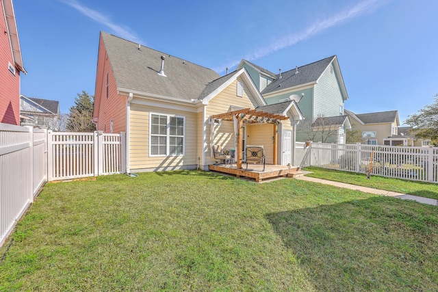 rear view of property with a fenced backyard, a pergola, a shingled roof, a deck, and a lawn