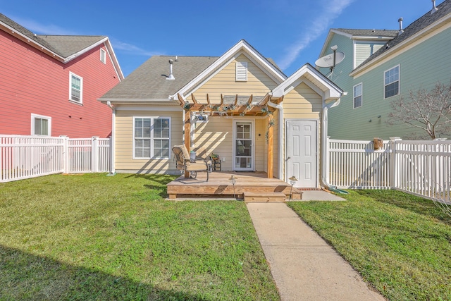 view of front facade featuring a front lawn, a pergola, a fenced backyard, a shingled roof, and a wooden deck