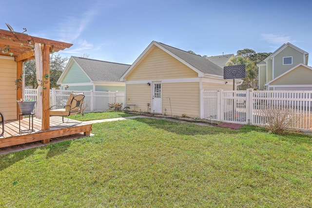 back of property featuring a fenced backyard, a wooden deck, and a yard