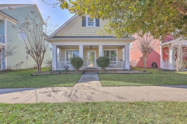 bungalow with a front lawn and covered porch