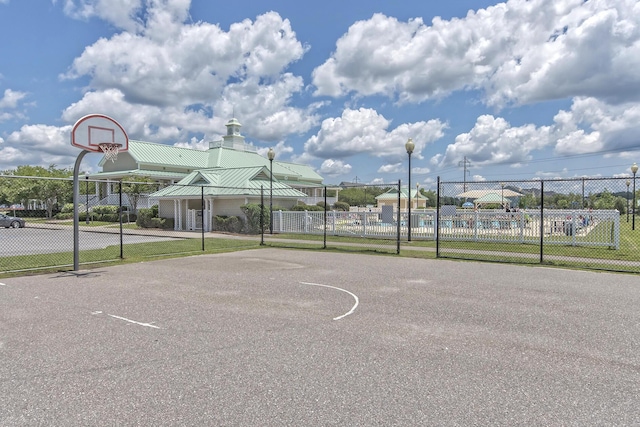 view of basketball court with community basketball court and fence