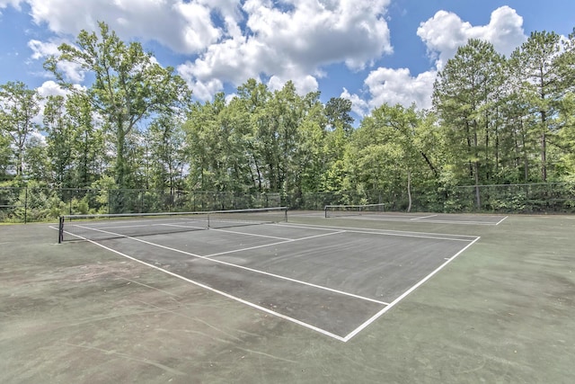 view of sport court featuring fence