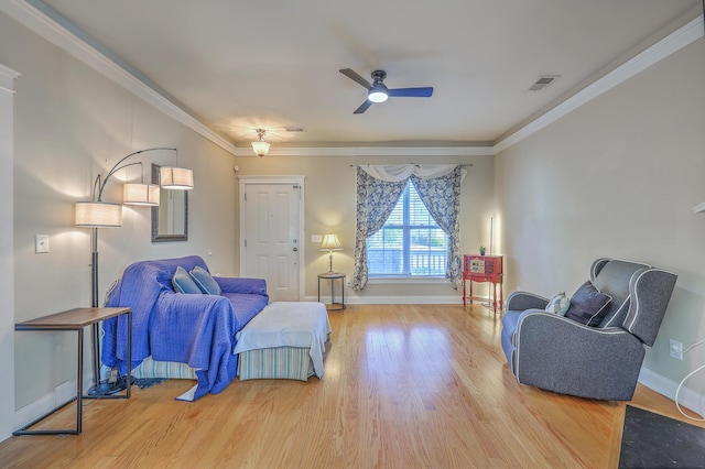 living room featuring visible vents, crown molding, baseboards, and wood finished floors