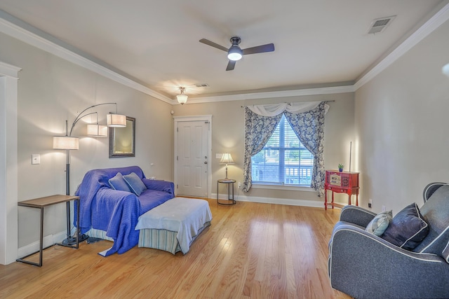 bedroom with visible vents, baseboards, wood finished floors, and ornamental molding