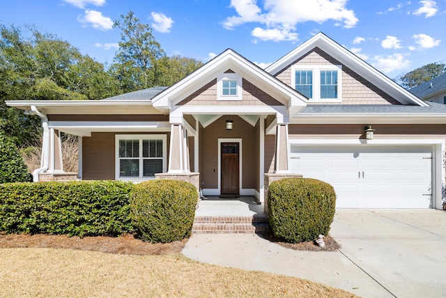 craftsman house with concrete driveway and an attached garage