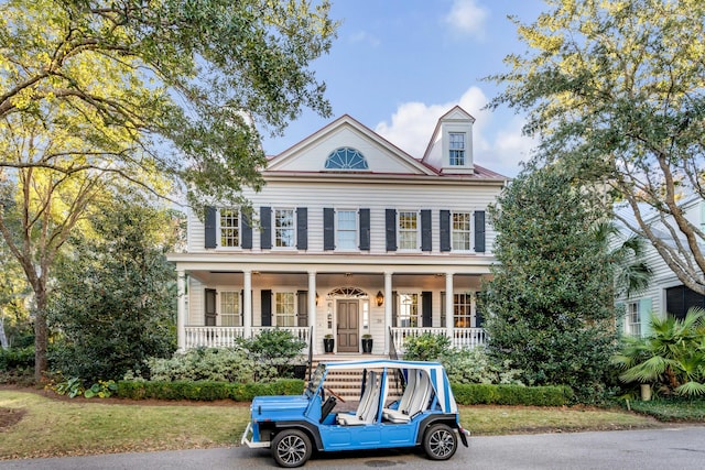 greek revival inspired property featuring covered porch